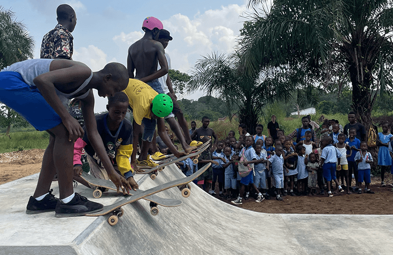 Image of Makomp Skatepark, skaters about to drop in a bowl